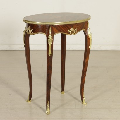 Oval coffee table with bronze and inlaid-detail