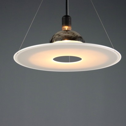 'Frisbi 850' lamp by,Achille Castiglioni,Achille Castiglioni (1918–2002) was the only Italian architect and designer to whom the MoMA in New York has dedicated a retrospective so far. He completed his studies at the Politecnico di Milano in 1944. A 360-degree designer he was involved in urban planning, architecture, exhibitions, and product design.nIn 1956, he co-founded the Associazione per il Disegno Industriale (ADI – Association for Industrial Design).nBetween 1952 and 1953, he worked on the reconstruction of the Palazzo della Permanente in Milan. From 1955 to 1979, he won seven Compasso d'Oro awards, the last one for the Parentesi lamp designed with Pio Manzù. He was also awarded multiple times at the Triennale: Bronze Medal in 1947, Grand Prize in 1951 and 1954, Silver and Gold Medals in 1957, Gold in 1960, and Silver again in 1963.nIn 1971, he began teaching at the Faculty of Architecture at the Polytechnic of Turin.nHis signature, often alongside that of his brother Pier Giacomo, can be found on countless modernists creations produced for many brands including Kartell, Zanotta, Flos, Bernini, Siemens, Knoll, Poggi, Lancia, Alessi, Ideal Standard, and Arflex.n,Achille Castiglioni,Achille Castiglioni,Achille Castiglioni