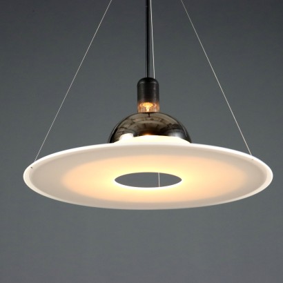 'Frisbi 850' lamp by,Achille Castiglioni,Achille Castiglioni (1918–2002) was the only Italian architect and designer to whom the MoMA in New York has dedicated a retrospective so far. He completed his studies at the Politecnico di Milano in 1944. A 360-degree designer he was involved in urban planning, architecture, exhibitions, and product design.nIn 1956, he co-founded the Associazione per il Disegno Industriale (ADI – Association for Industrial Design).nBetween 1952 and 1953, he worked on the reconstruction of the Palazzo della Permanente in Milan. From 1955 to 1979, he won seven Compasso d'Oro awards, the last one for the Parentesi lamp designed with Pio Manzù. He was also awarded multiple times at the Triennale: Bronze Medal in 1947, Grand Prize in 1951 and 1954, Silver and Gold Medals in 1957, Gold in 1960, and Silver again in 1963.nIn 1971, he began teaching at the Faculty of Architecture at the Polytechnic of Turin.nHis signature, often alongside that of his brother Pier Giacomo, can be found on countless modernists creations produced for many brands including Kartell, Zanotta, Flos, Bernini, Siemens, Knoll, Poggi, Lancia, Alessi, Ideal Standard, and Arflex.n,Achille Castiglioni,Achille Castiglioni,Achille Castiglioni