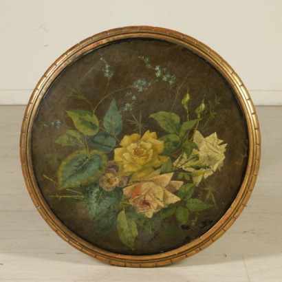 A small round table with painted detail