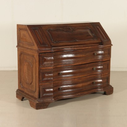 The chest of drawers to the fore in walnut