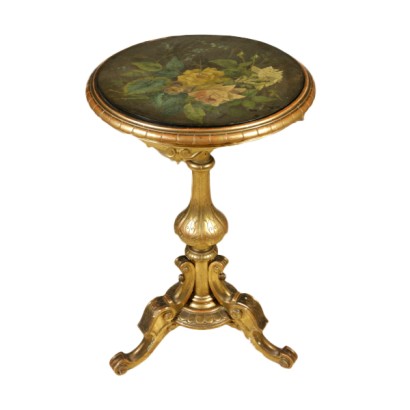 A small round table with a painting